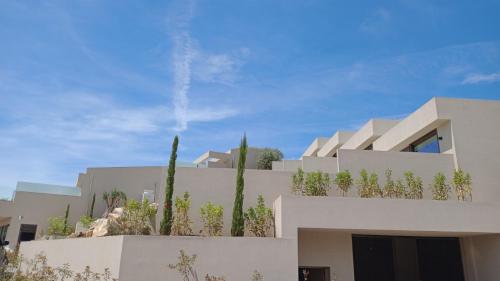 a white house with plants on the side of it at Sivota Sun Side Serenity in Sivota