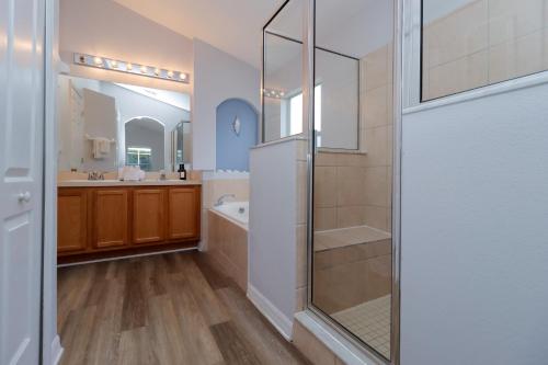 a large bathroom with a shower and a sink at Quiet Getaway Nr Golf & Posner Park with Pool in Davenport
