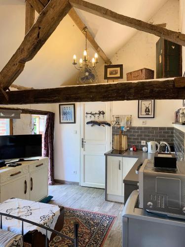 a kitchen with white cabinets and a ceiling with beams at Chateau Mareuil in Brigueuil-le-Chantre