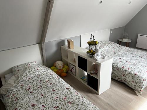 - une chambre avec un lit et une table de chevet à côté dans l'établissement Maison au cœur de la forêt, à Râches