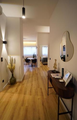 a living room with a wooden floor and a table at Crystal Palace Oporto Flat - With Two Bedrooms in Porto