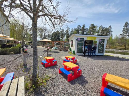 a toy store with colorful tables and benches outside at Norrqvarn Hotel & Resort by Vänerport in Lyrestad