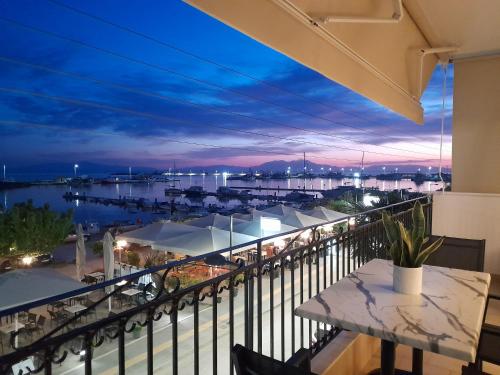 a balcony with a view of a marina at night at Zozi's home N.MOYDANIA in Nea Moudania