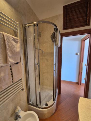 a bathroom with a shower with a sink and a toilet at Appartamento La Casetta in Varazze