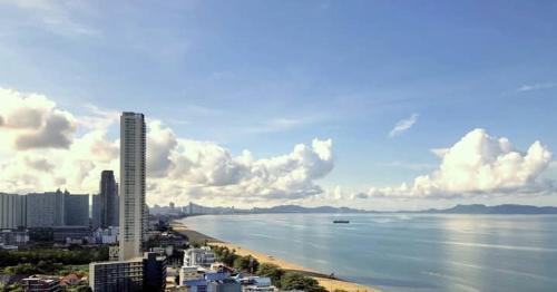 a view of a city and the ocean with a tall building at 1 x bedroom Jomtien oceanview 34sqm 28 floor วิวทะเลgus in Jomtien Beach
