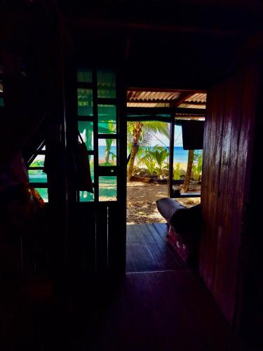 an open door to a room with a view of the ocean at Shared Beach House in Drake