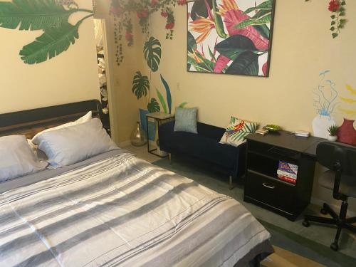 a bedroom with a bed and a desk and a chair at Botanical Tranquility in Orlando
