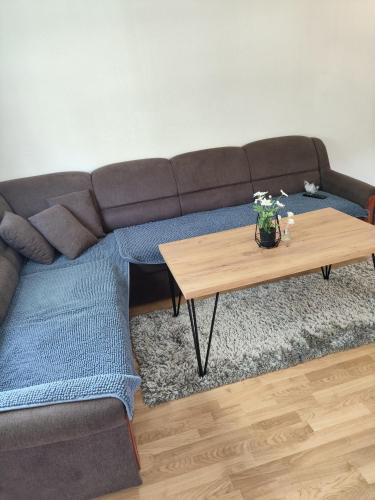 a living room with a couch and a coffee table at Oaza mira Šipovo in Šipovo