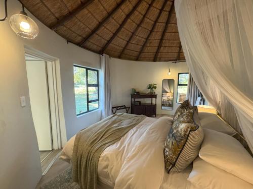 a bedroom with a bed with a canopy at Heritage View Birding Retreat in Delareyville