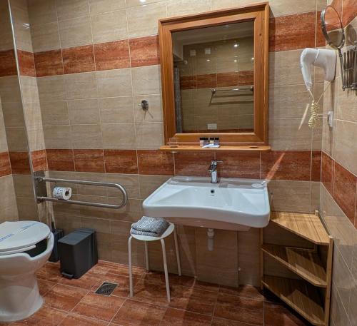 a bathroom with a sink and a toilet at Althea Apartments in Katakolon