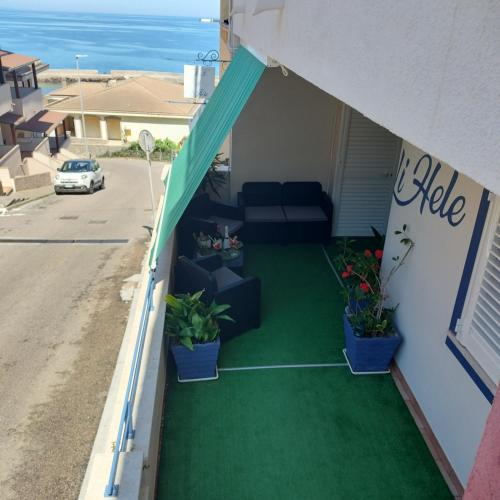 a balcony with a couch and a tent at Casa Vacanza LiHele - Locazione Turistica in Castelsardo