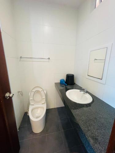 a bathroom with a toilet and a sink at Bay Resort condominium Miri in Miri