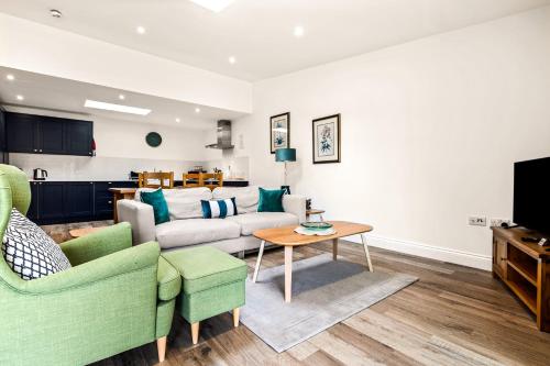 a living room with a couch and a table at Cart Shed 1 in Oxford