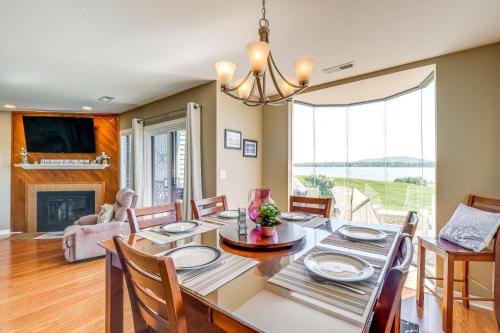 a dining room and living room with a table and chairs at Sun-Filled Condo with Smith Mountain Lake Views in Moneta
