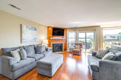 a living room with a couch and a fireplace at Sun-Filled Condo with Smith Mountain Lake Views in Moneta