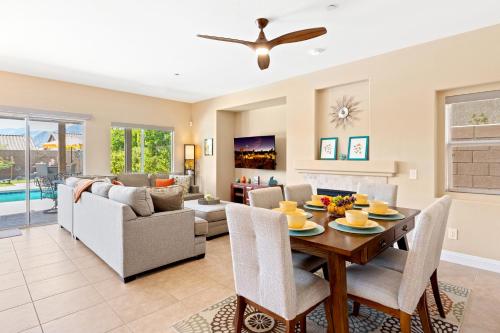 a dining room and living room with a table and chairs at Stunning 5 Star Oasis in Palm Springs