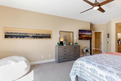 a bedroom with a bed and a ceiling fan at Stunning 5 Star Oasis in Palm Springs