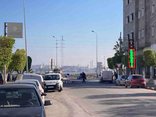 a group of cars parked on a street with a traffic light at Dar Yassine in Sahline