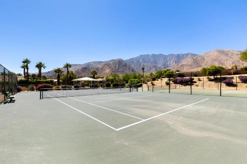 a tennis court with two tennis rackets on it at Stunning 5 Star Oasis in Palm Springs