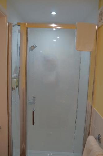 a shower with a glass door in a bathroom at Radcliffe Guest House in Ross on Wye