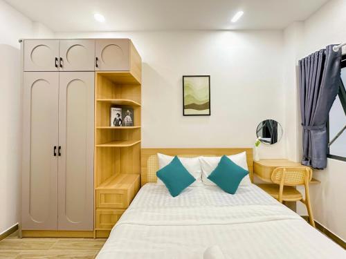 a small bedroom with a bed and a desk at Urbanest Saigon in Ho Chi Minh City