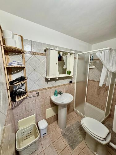 a bathroom with a toilet and a sink and a shower at No Vabbè! Penthouse… in Torre Santa Susanna