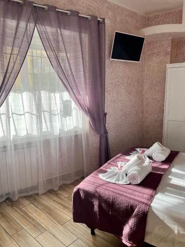 a bedroom with two beds and a window at Paganino rooms in Fiumicino