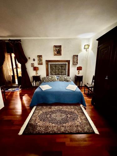 a bedroom with a bed with a blue bedspread at No Vabbè! Penthouse… in Torre Santa Susanna