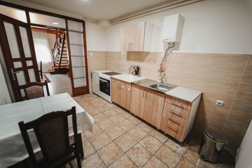 a kitchen with a sink and a table in it at B&B Passage in Sremska Mitrovica