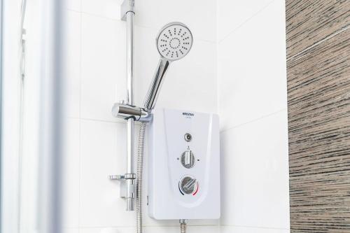 a shower in a bathroom with a shower head at Central Apartment - Sheffield in Sheffield