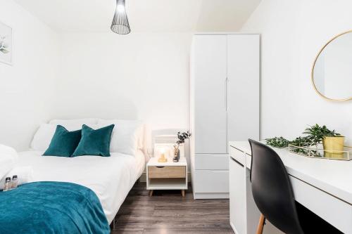 a white bedroom with a bed and a mirror at Central Apartment - Sheffield in Sheffield