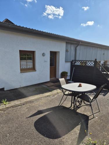 a table and chairs in front of a house at Hotel Panorama in Wees