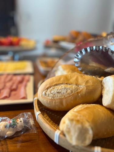 a tray of breads on a table with a plate at Pousada Cores do Pelô in Salvador