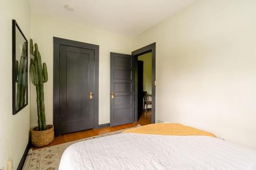 a bedroom with two doors and a cactus at Stay Portland - Moab Vibes in PDX- Walk to Local Coffee & Food in Portland