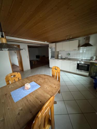 a wooden table and chairs in a kitchen at Hotel Panorama in Wees