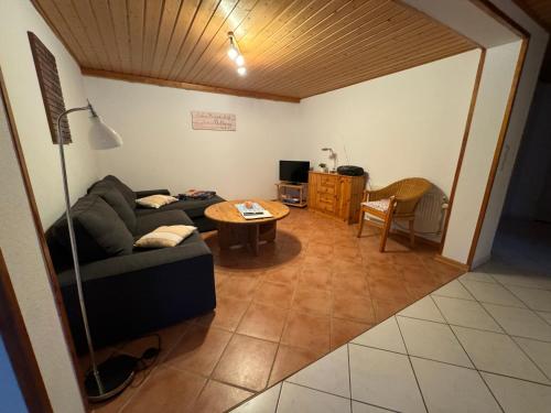 a living room with a couch and a table at Hotel Panorama in Wees
