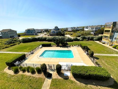 an aerial view of a large yard with a swimming pool at D134B- Vacay Vibes in Duck