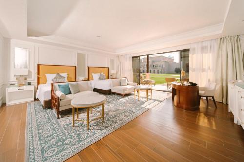 a living room with a couch and a table at Royal Saray Resort in Manama