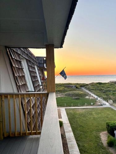 a view of the ocean from a balcony with a kite at D134B- Vacay Vibes in Duck