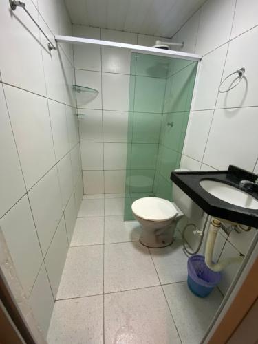a bathroom with a toilet and a sink at Suítes nativa in Trairi