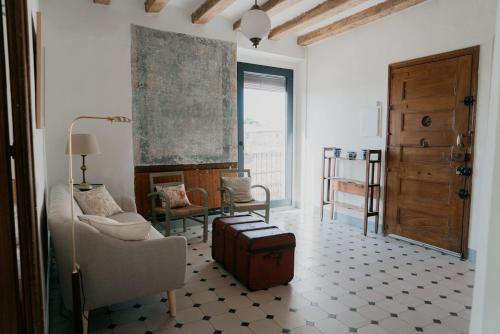 a living room with a suitcase on the floor at Wine Country stay at Ca Escoda between Montsant and Priorat on the Ebro Riverside in Darmós