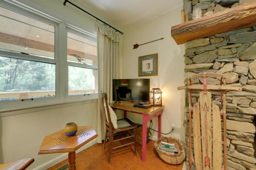 a home office with a desk and a stone wall at Creek Access Quiet Bryson City Retreat with Hot Tub in Bryson City