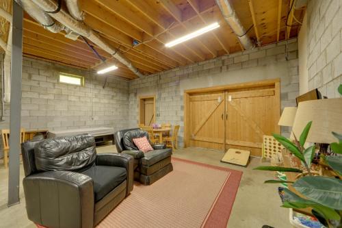 a living room with two chairs and a couch and a table at Creek Access Quiet Bryson City Retreat with Hot Tub in Bryson City