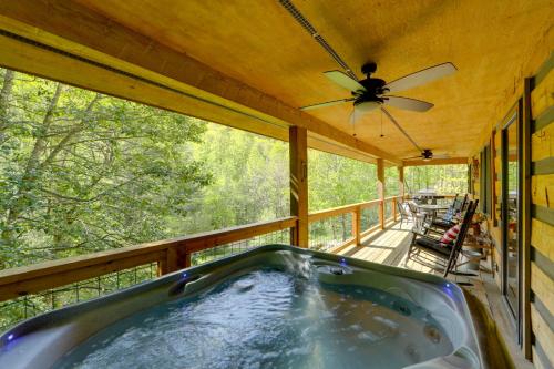 a hot tub on a porch with a ceiling fan at Creek Access Quiet Bryson City Retreat with Hot Tub in Bryson City