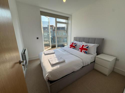 a bedroom with a bed with a large window at Penthouse on the Grange in London