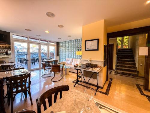 a living room with a table and some chairs at Hotel Verdemar in Ribadesella
