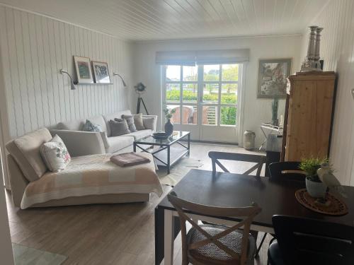 a living room with a couch and a table at Cozy house with sea view at Husvik, 3 bedrooms in Tønsberg