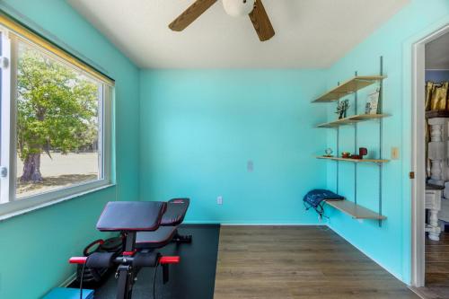 a home gym with blue walls and a chair at 3BR Wesley Chapel Retreat with Private Pool - Pet-Friendly - Spacious Parking in Zephyrhills