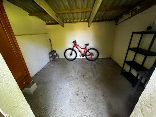 a red bike is parked in a room at ROULOTTE NATIRAA in Tarascon