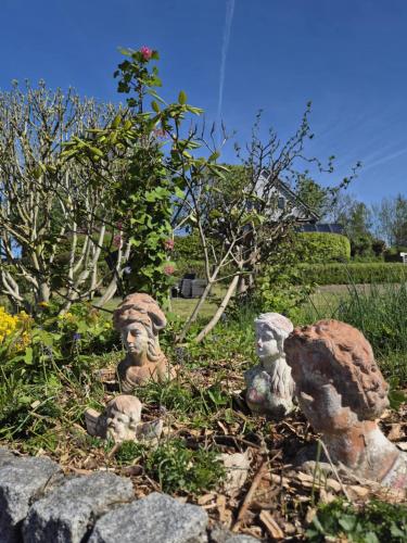 a group of statues in a garden with rocks at Hotel Panorama in Wees